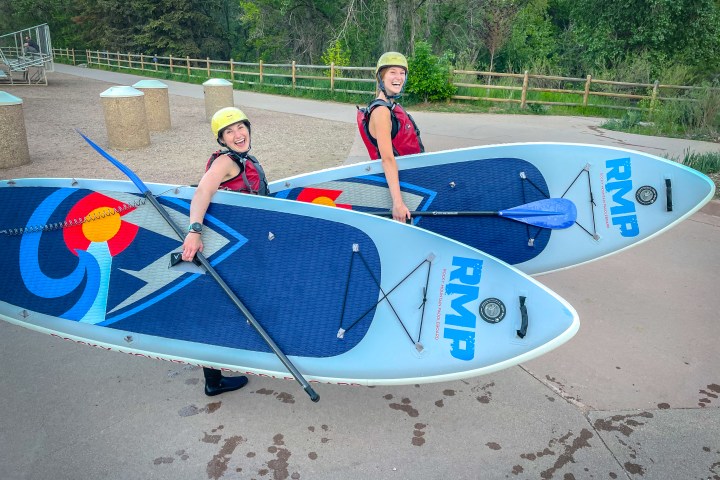 girls learning how to white water paddleboard