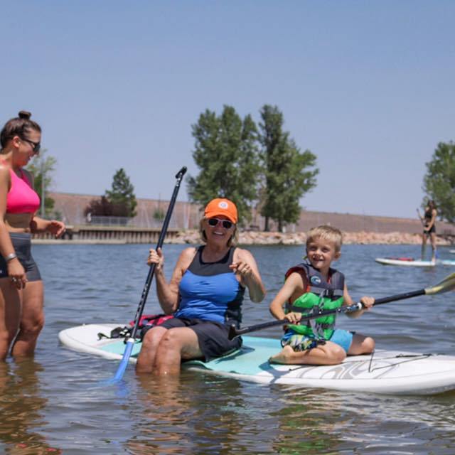 a group of people rowing a boat in the water