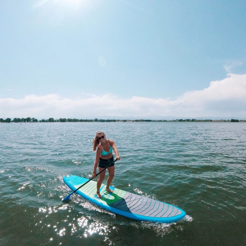 a person riding a surf board on a body of water