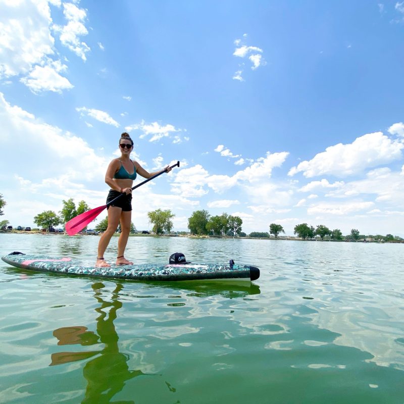 a man riding on the back of a boat in the water