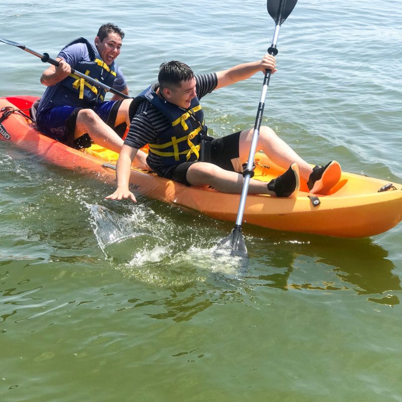 a group of people in a small boat in a body of water