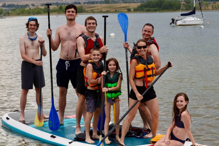 a group of people standing next to a body of water