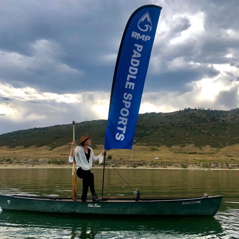 a man standing on a boat in a body of water