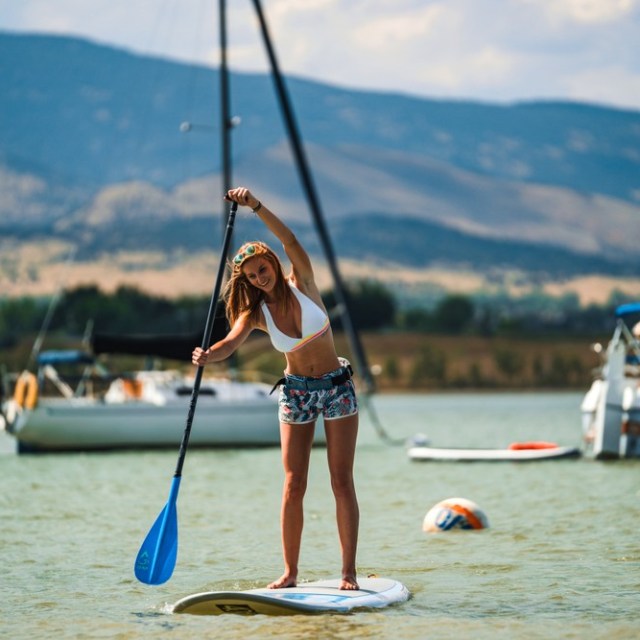 a person standing next to a body of water