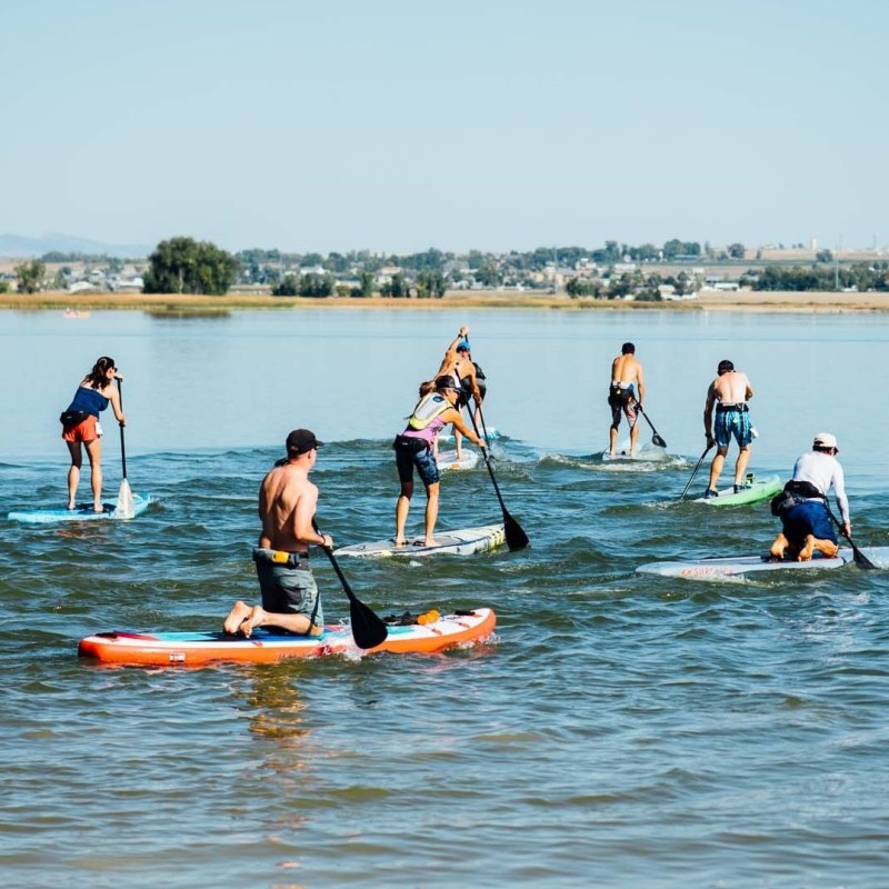 a group of people rowing a boat in the water