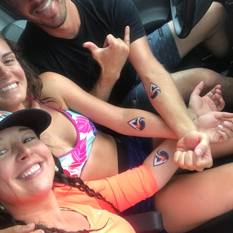 a group of people sitting around a car