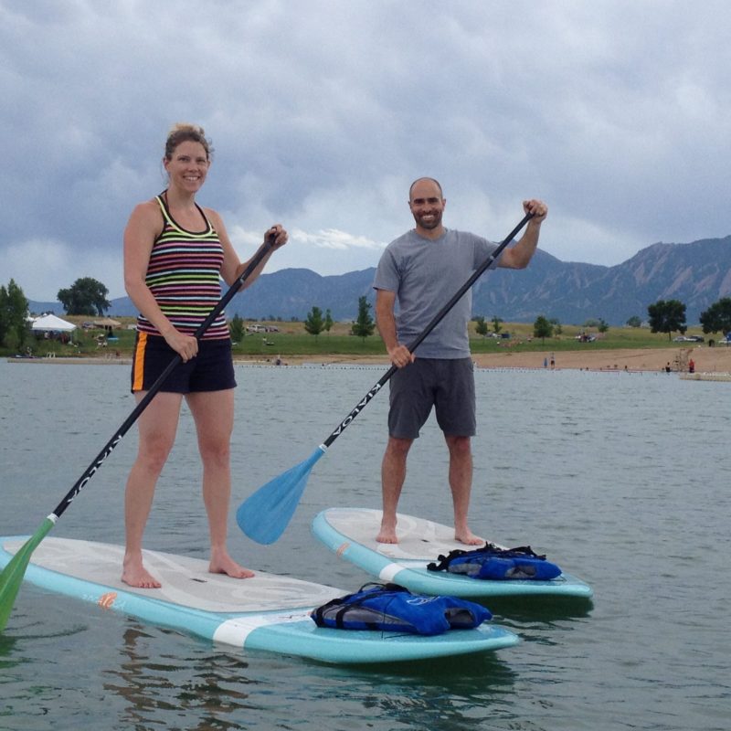 a person standing next to a body of water