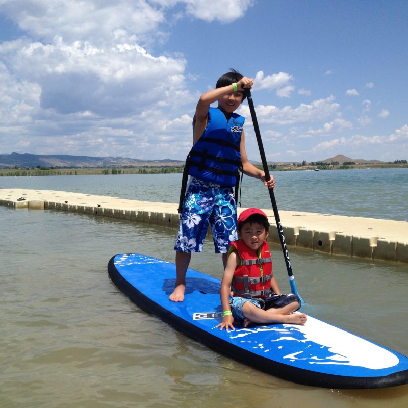 a person riding on the back of a boat in a body of water
