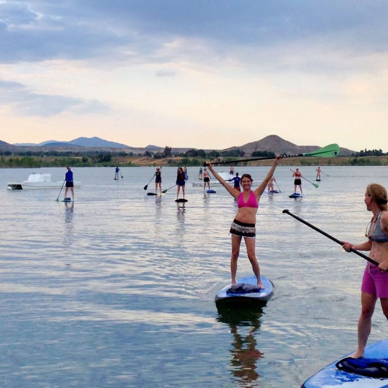 a person standing next to a body of water