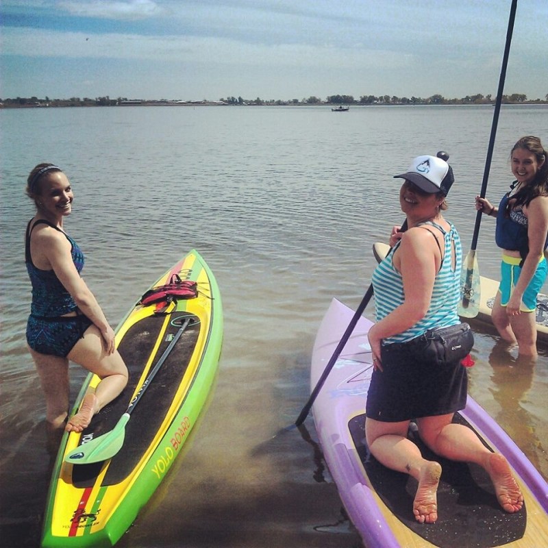 a person standing next to a body of water