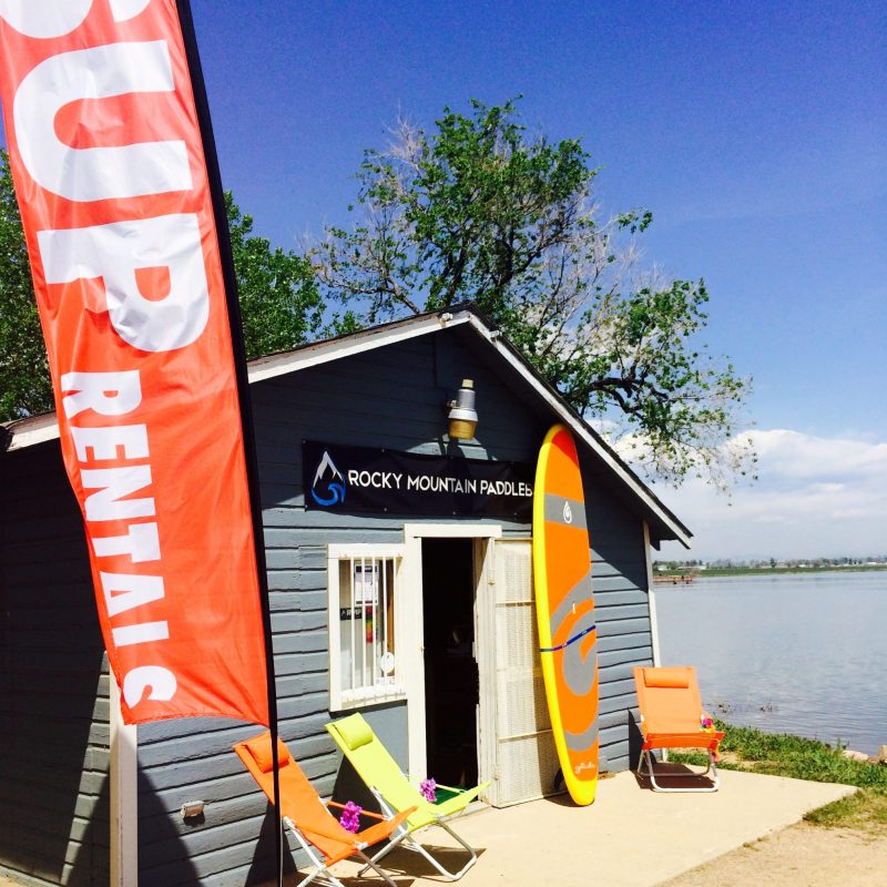 a group of people flying kites on a beach