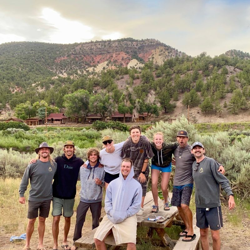 a group of people standing on top of a mountain