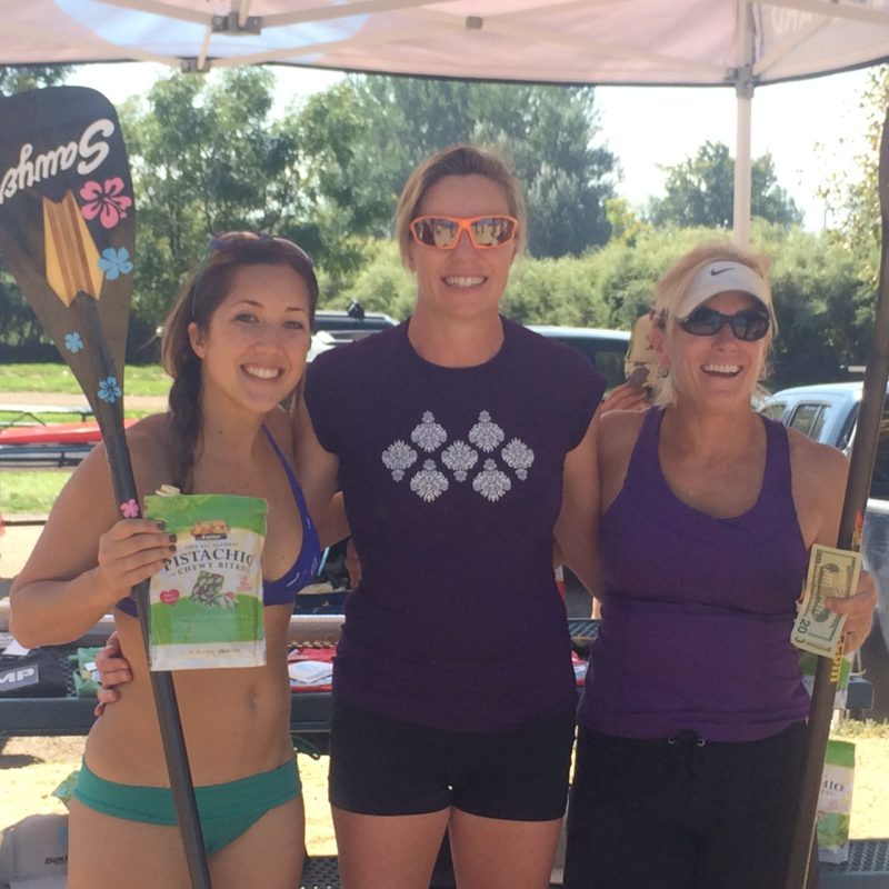 a woman standing in front of a group of people posing for the camera