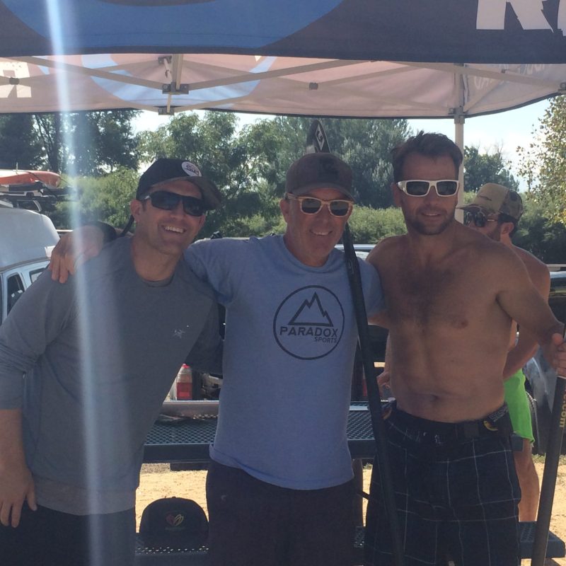 a man standing in front of a group of people posing for the camera