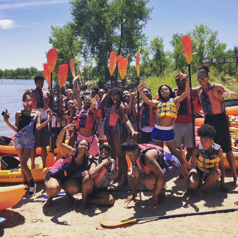 a group of people on a beach posing for the camera