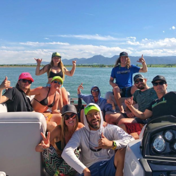 a group of people standing in front of a body of water